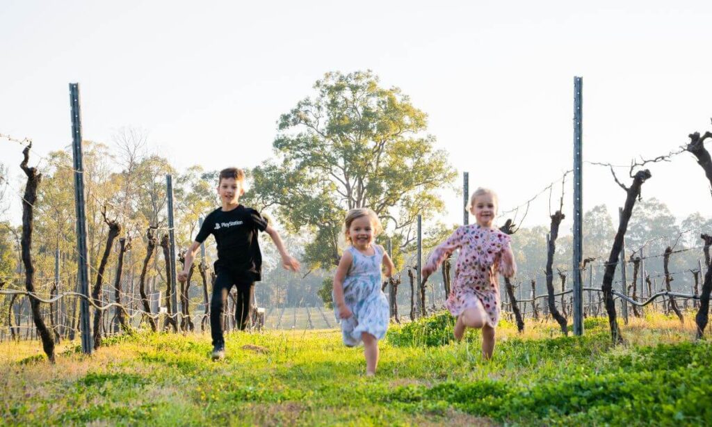 Children running in saddlers vineyard