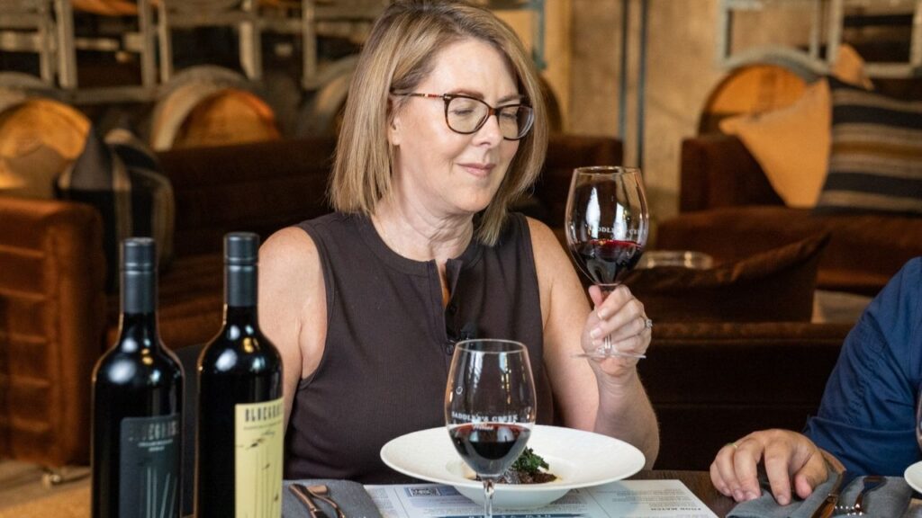 Guest tasting Bluegrass red wine during a food pairing