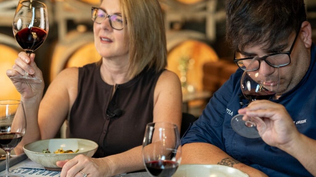 Guests comparing red wine with a paired degustation dish