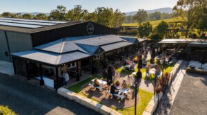 Saddlers Creek Wines cellar door and wine garden in Pokolbin Hunter Valley with guests enjoying wine tasting on a sunny afternoon
