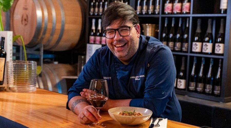Chef Chiero of Mangia at Saddler's with a glass of red wine at Saddler's Creek Wines